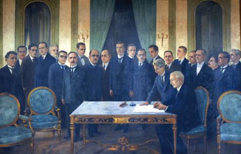 Pintura a óleo registra o momento em que o presidente de Minas, Antônio Carlos de Andrada (sentado), sanciona a lei que criou a então UMG